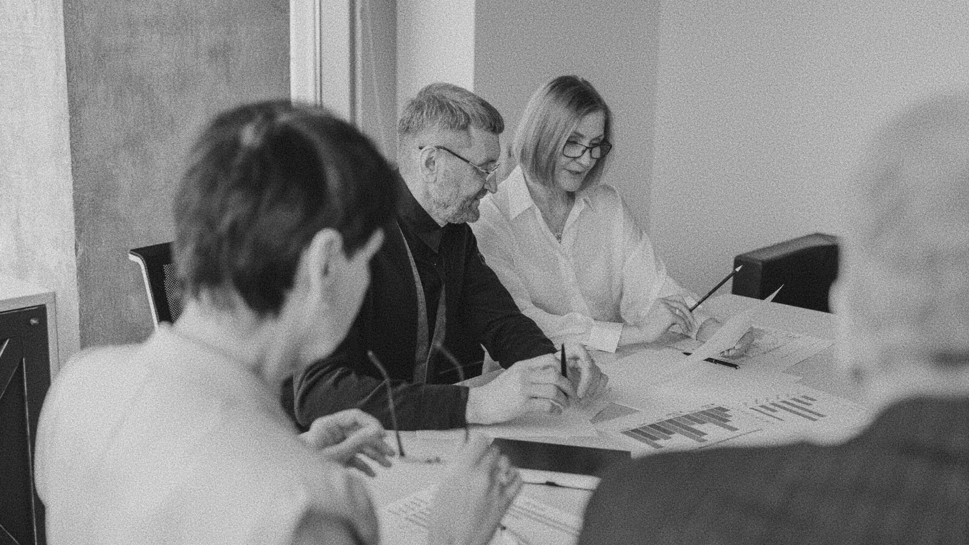 A business meeting with three individuals.