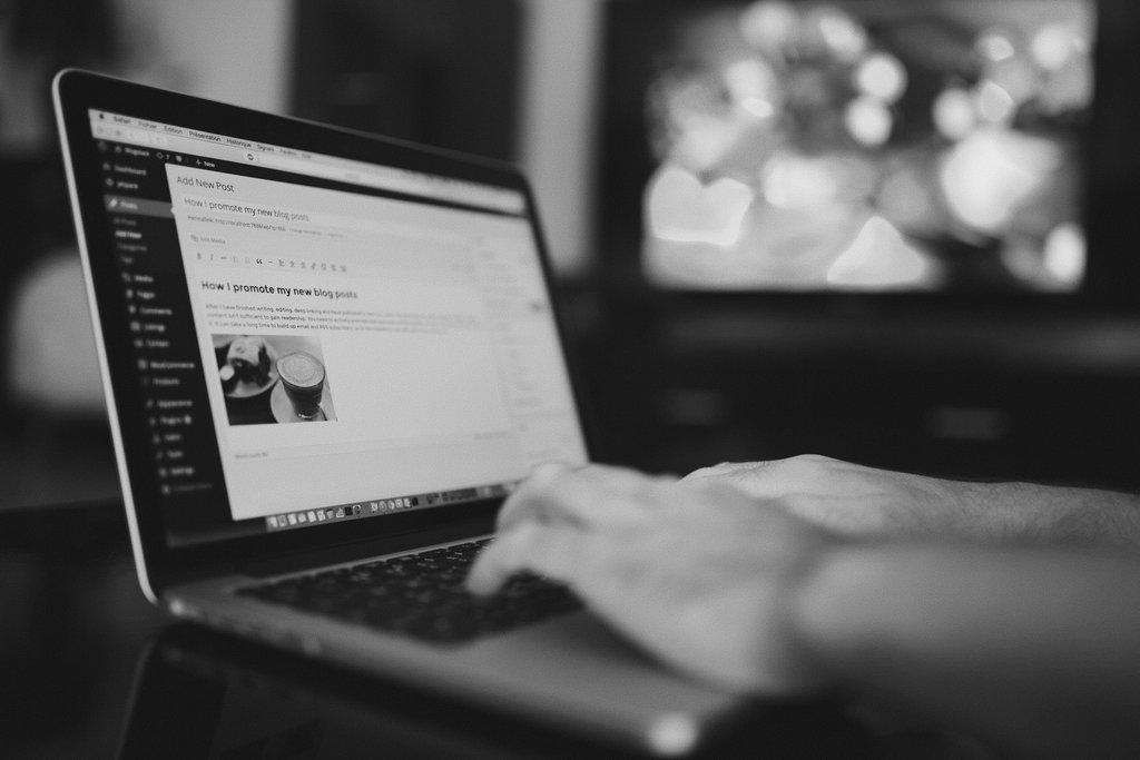 Writing a blog post on a laptop.