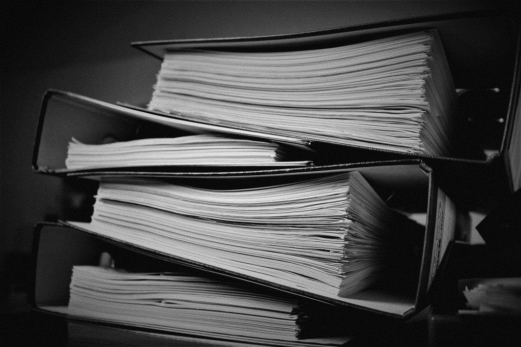 A stack of binders containing a ton of information.