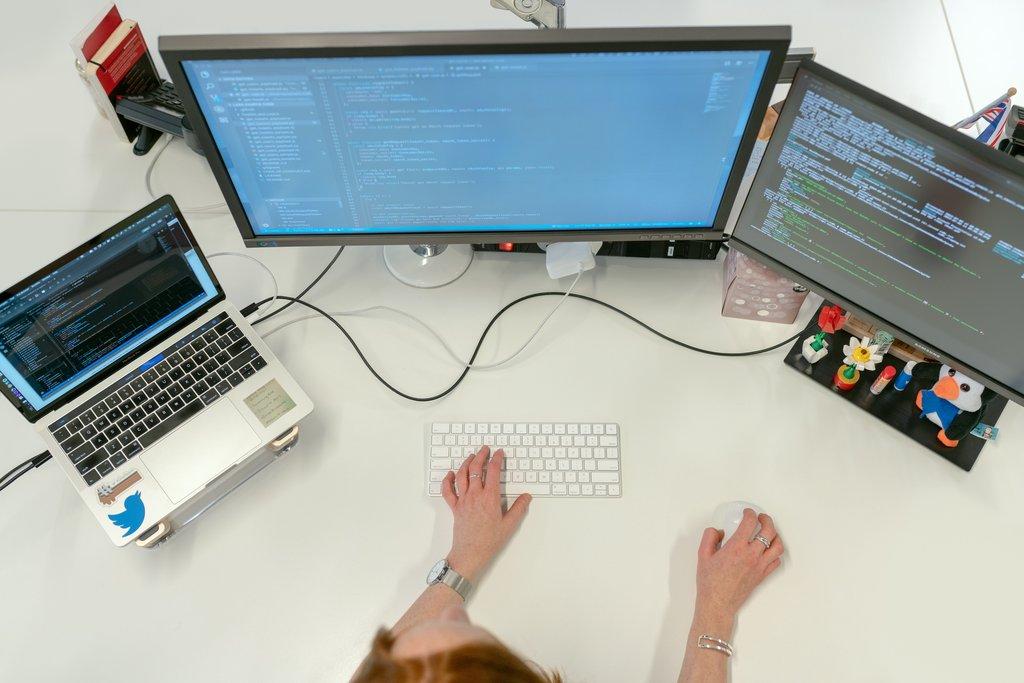 Cascadia engineer writing WordPress code across dual monitors.