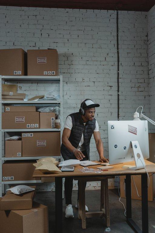 Online store owner managing WooCommerce orders on a laptop.