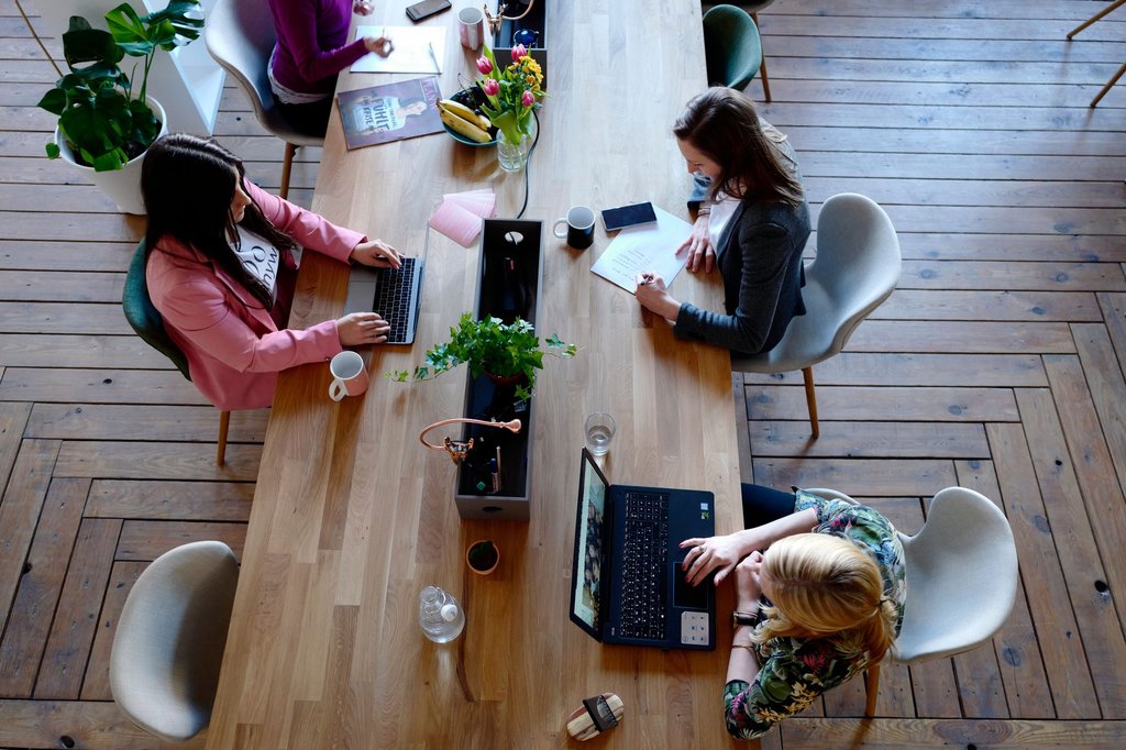 Team reviewing several connected business apps on a shared monitor.