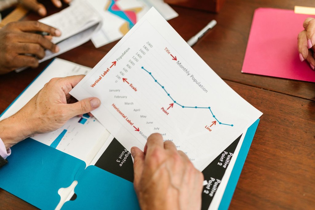 A printed project timeline on the table during a scheduling meeting.