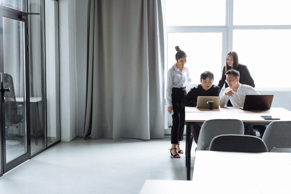 Operations team reviewing performance figures together at a desk.