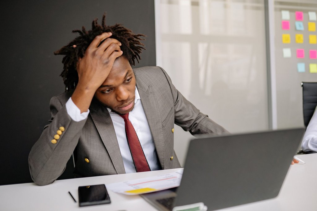 A man at a laptop working out how long a failure has gone unnoticed